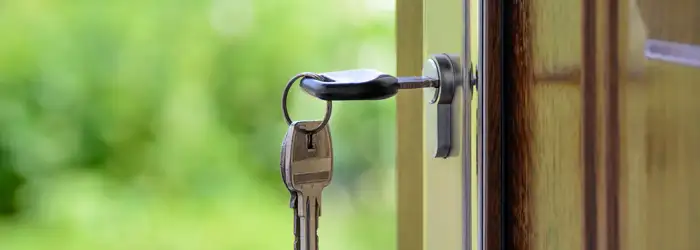 key inserted on wooden door