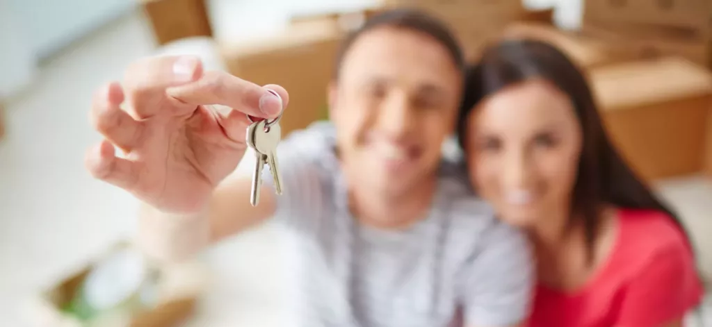 happy couple holding keys