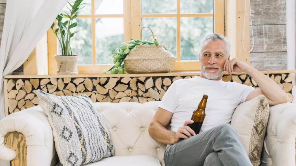 white haired man enjoying beer