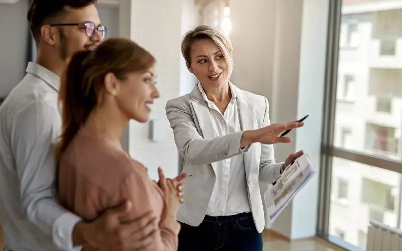 Estate agent showing couple around property