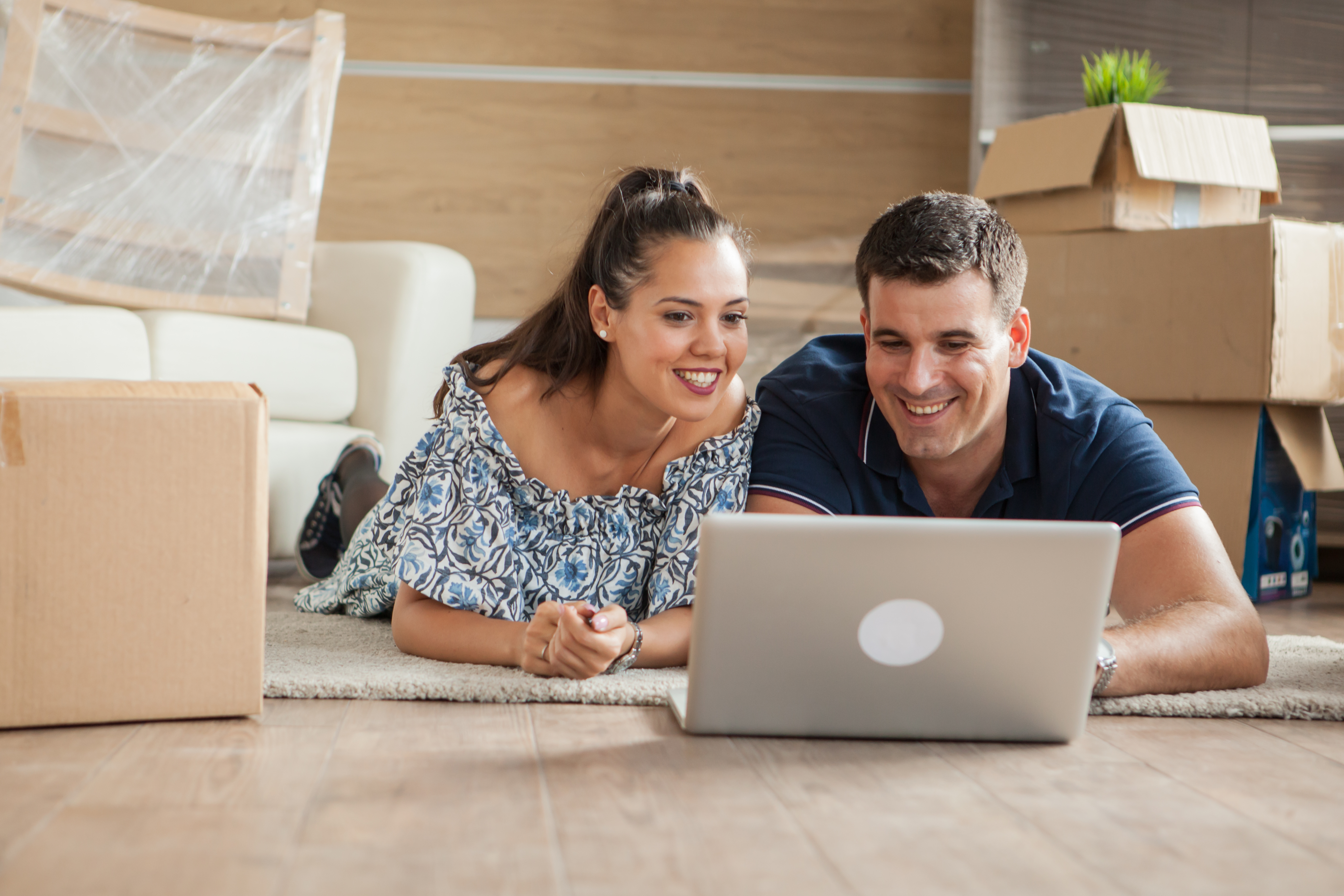 Husband and wife online shopping in new rental apartment