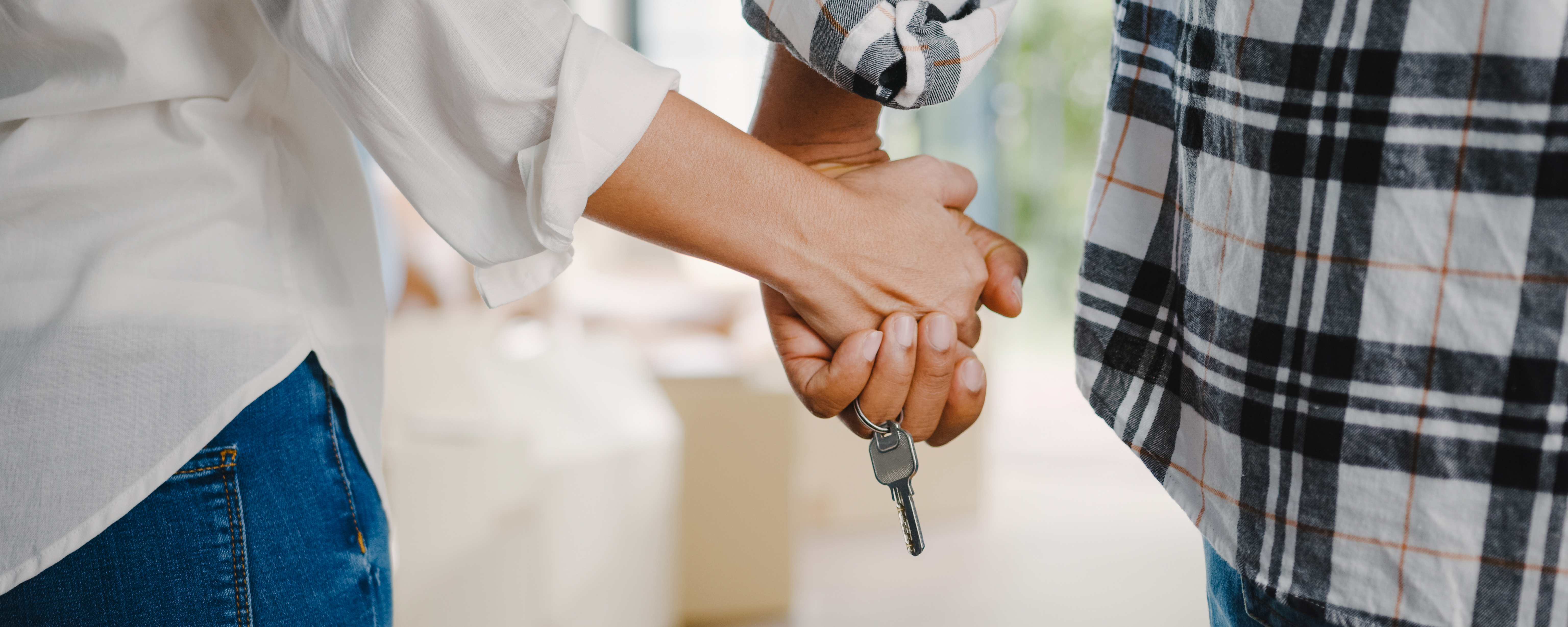 Young couple holding keys to property
