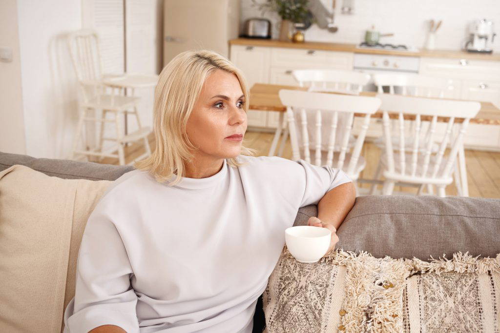 Lady drinking coffee in her home